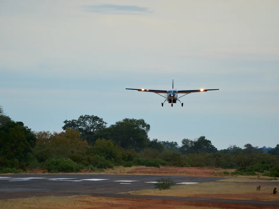 Cessna 208 Caravan on approach at dusk with landing lights on